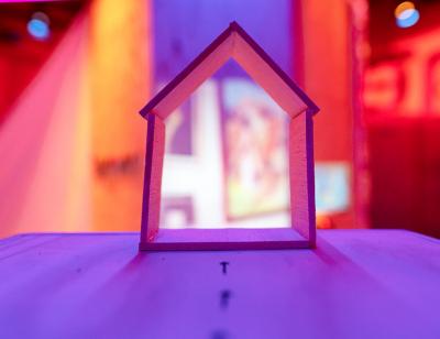 close up of wooden house with bright purple and yellow set. Photography by Anthony Lee 